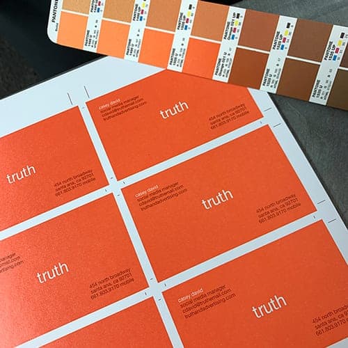 business cards being color matched to a Pantone book