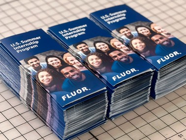stacked brochures sitting on a table