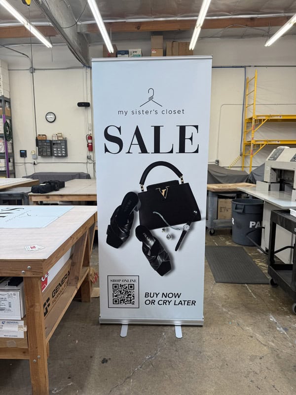 Retractable banner stand stating in a warehouse