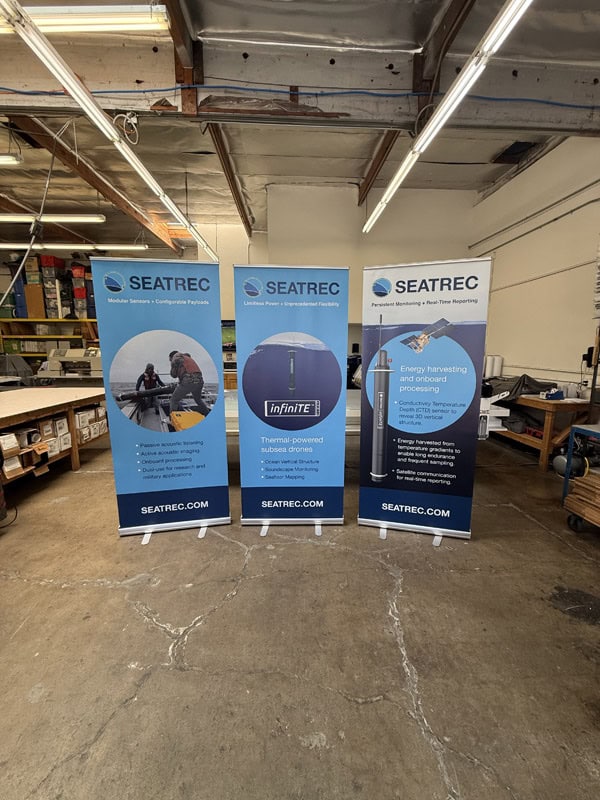 3 banner stands in a row