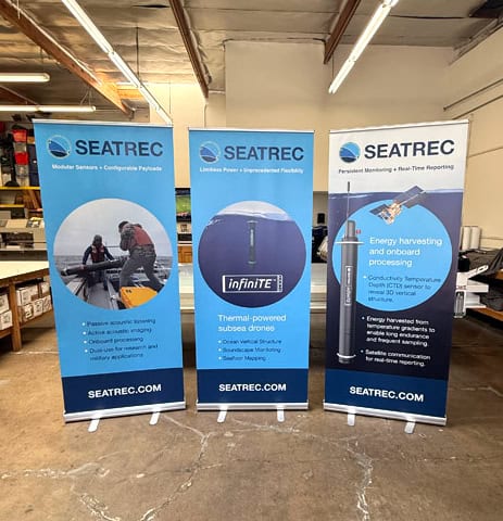 3 banner stands displayed in a warehouse