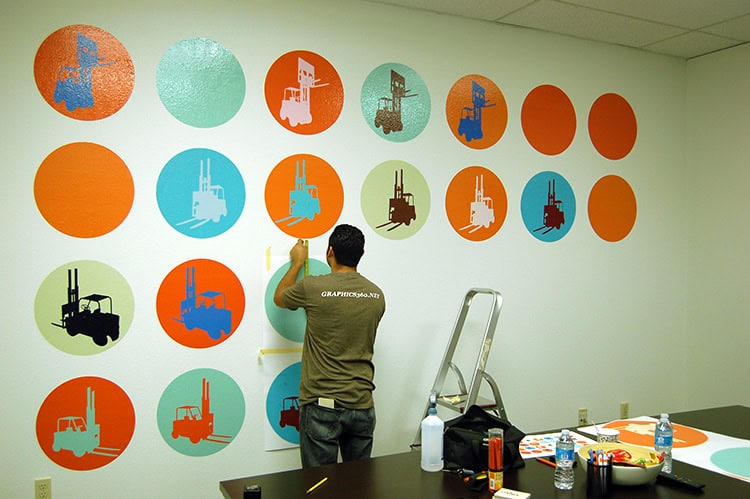 Wall decals being installed on a blank wall