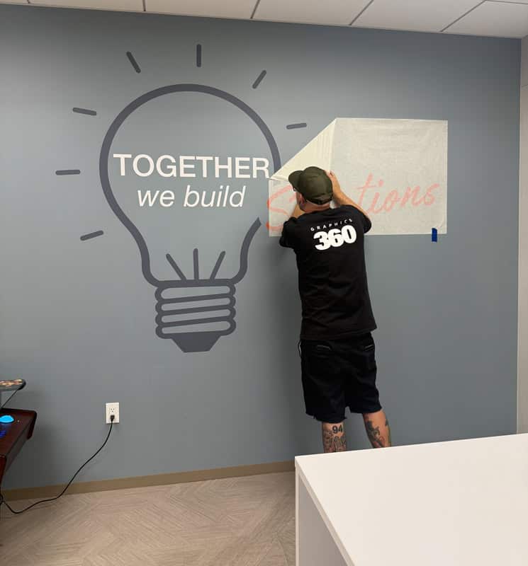 the installation of a partial wall graphic ion a kitchen